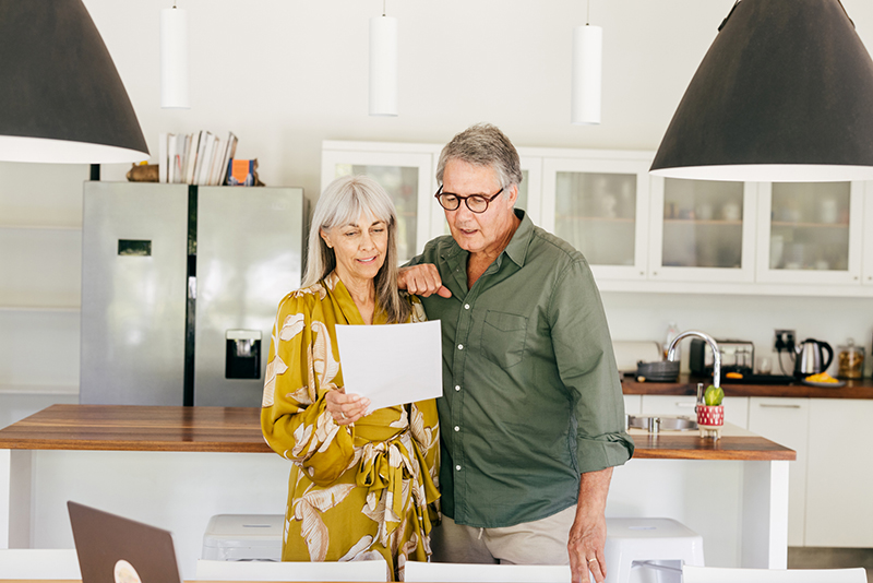 Couple with documents in the kitchen